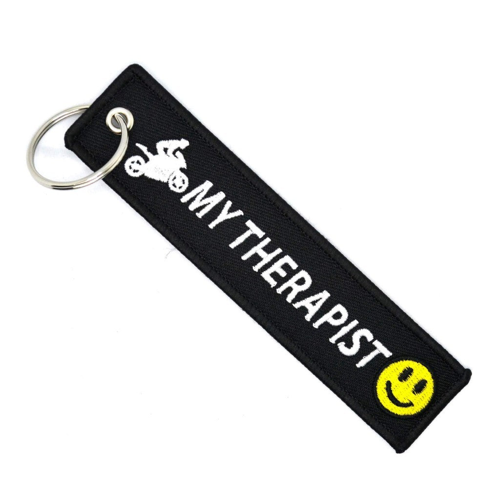 The keychain tag 'MOTOBIKE MY THERAPIST KEYCHAIN'